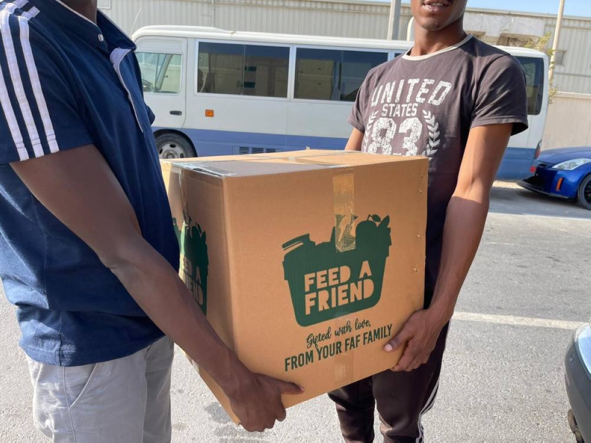 Volunteers assisting with the distribution of food boxes.