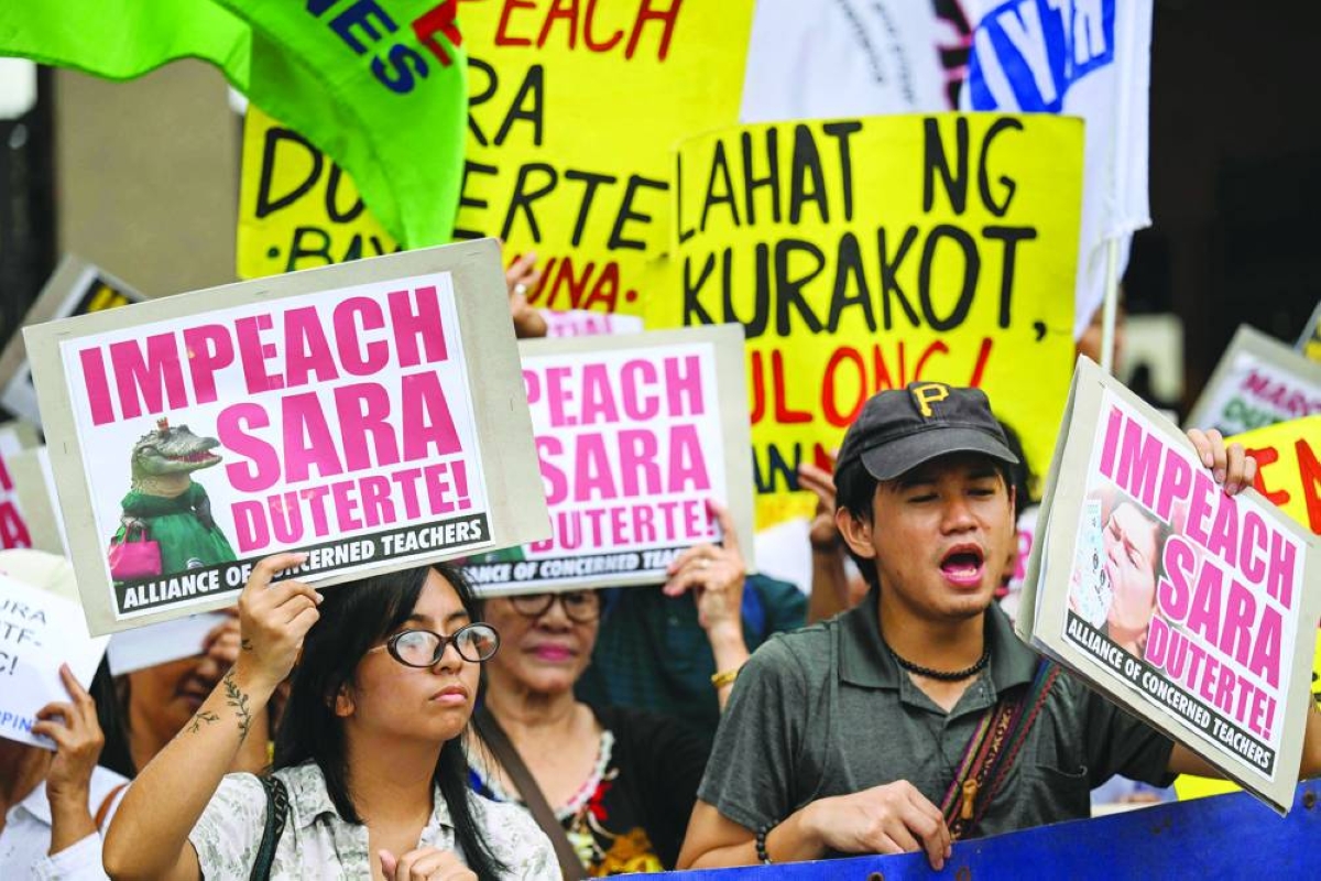 Protesters call for the impeachment of Philippine Vice-President Sara Duterte outside the House of Representatives in Quezon City, Metro Manila, on Monday. (AFP)
