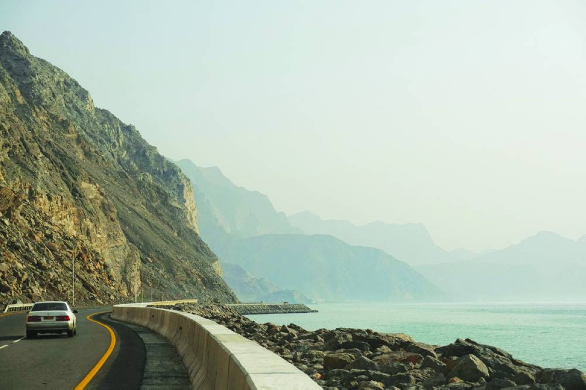 A car rides along the coast of Musandam in Oman, overlooking the Strait of Hormuz amid the US-Israeli conflict with Iran on Monday. Multiple attacks on vessels in recent days have choked off traffic through the narrow waterway. PICTURE: Reuters