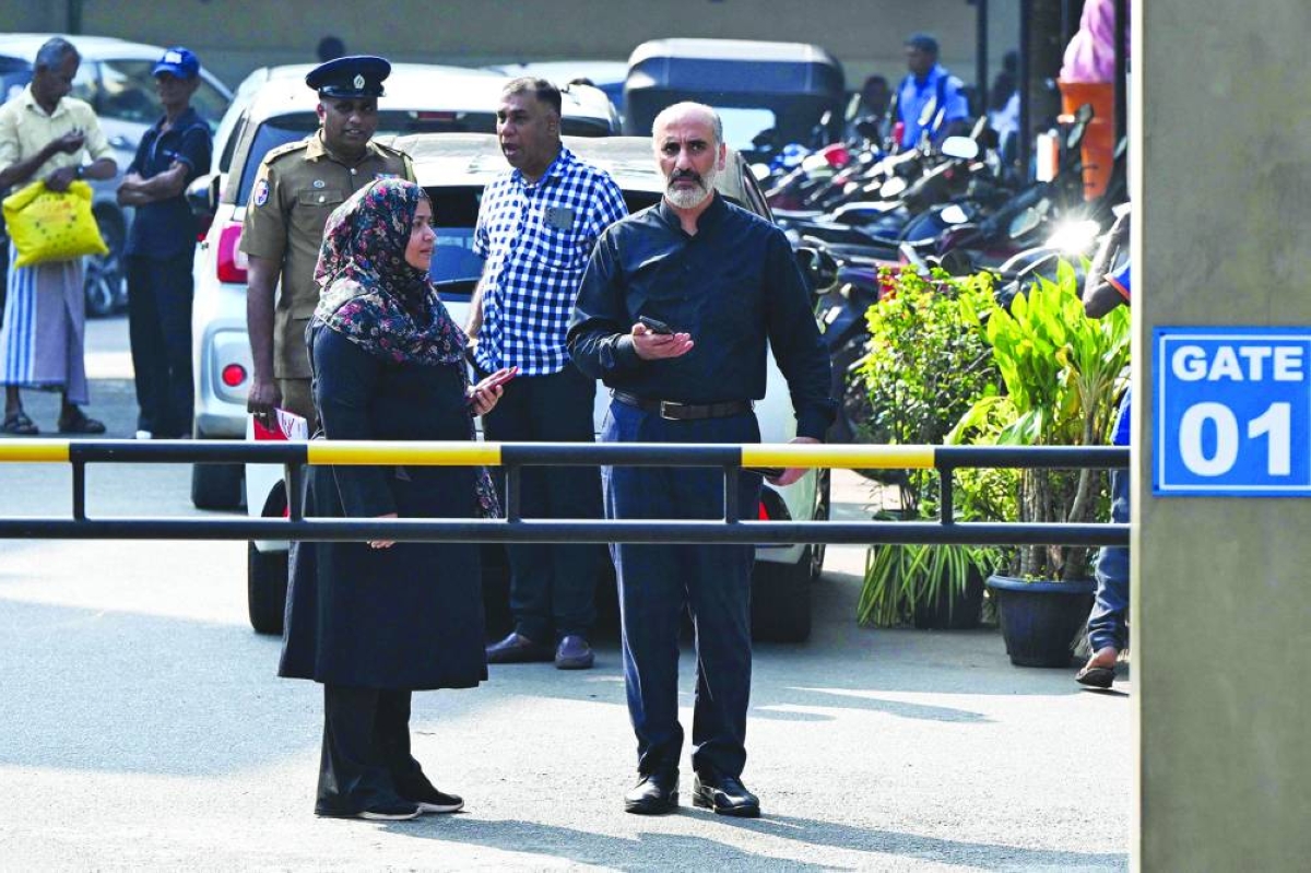 An Iran embassy staff member (right) stands outside the Karapitiya hospital in the southern city of Galle Thursday where the rescued Iranian sailors are being kept for treatment.