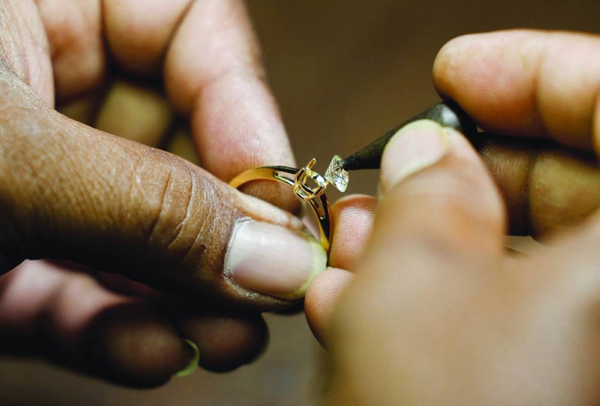 File photo: A man works on a diamond and gold ring inside a Senco Gold & Diamonds jewellery workshop in Kolkata, India.