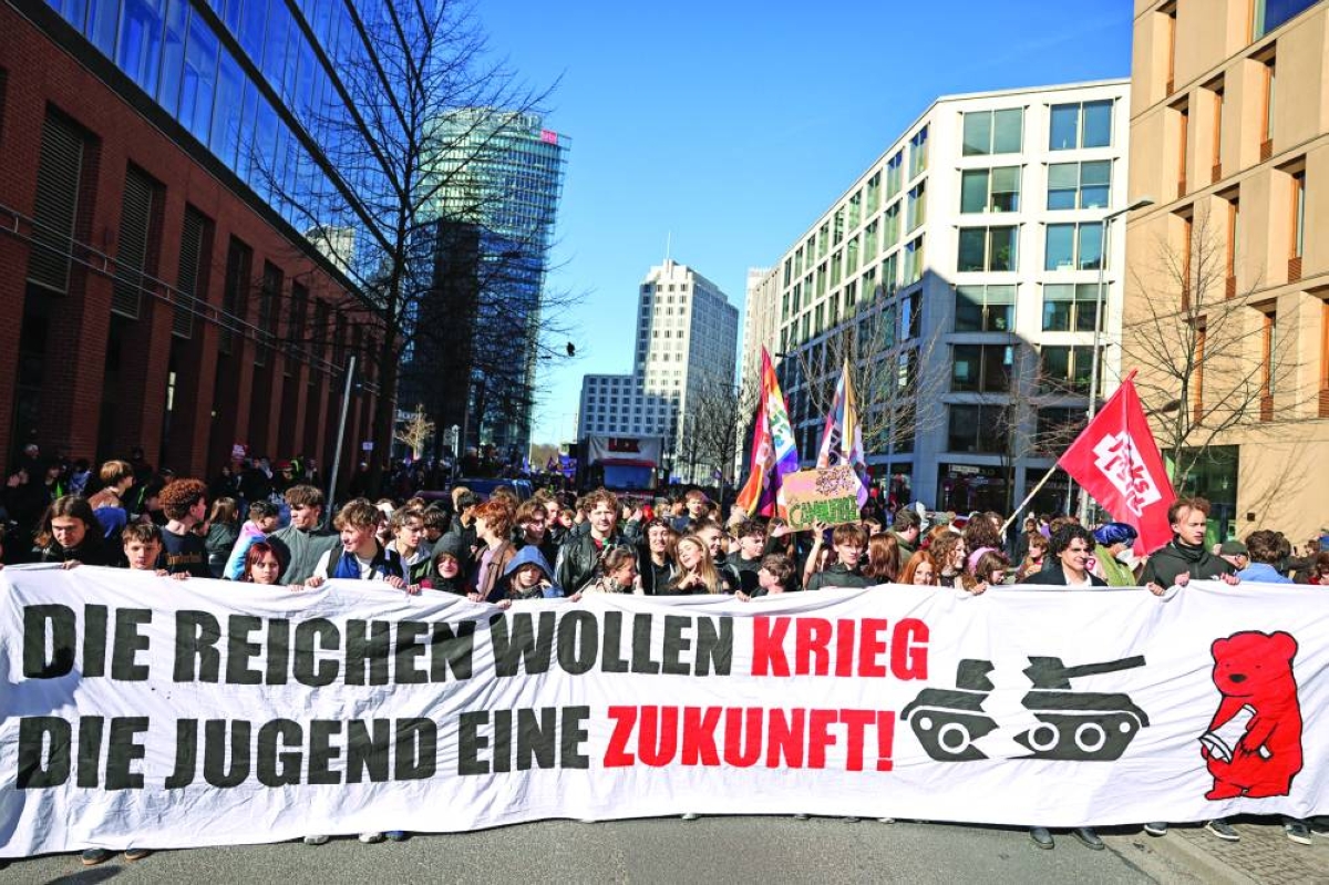 Demonstrators hold a banner that reads "The rich want war, the youth wants a future" during a protest against the potential return of military conscription in Berlin, Germany, Thursday.