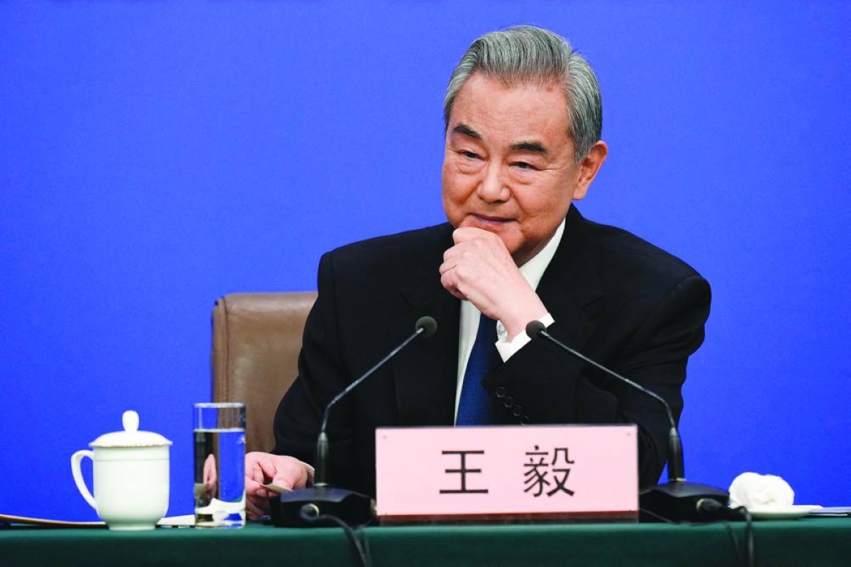 China's Foreign Minister Wang Yi, who is also a member of the Political Bureau of the Communist Party of China Central Committee, attends a press conference in Beijing Sunday. ((AFP)