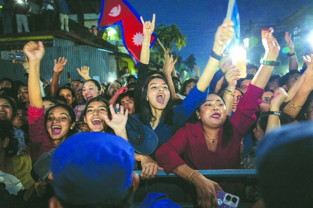 Supporters of Balendra Shah celebrate after Shah won the election, in Damak, Jhapa district, Nepal, on Saturday. (Reuters)