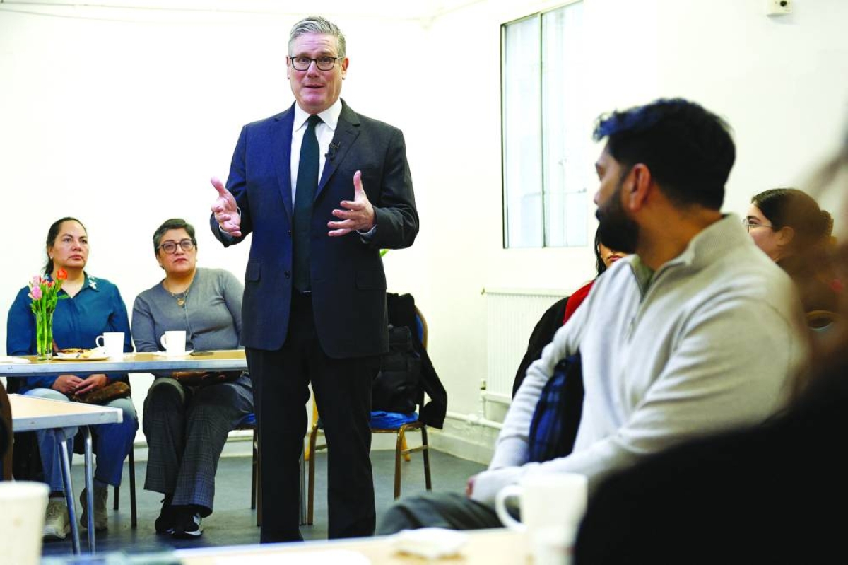 Britain's Prime Minister Keir Starmer speaks to people during a visit to a community centre, about how the government is handling the impacts of the conflict in the Middle East, in London, Monday. (Reuters)