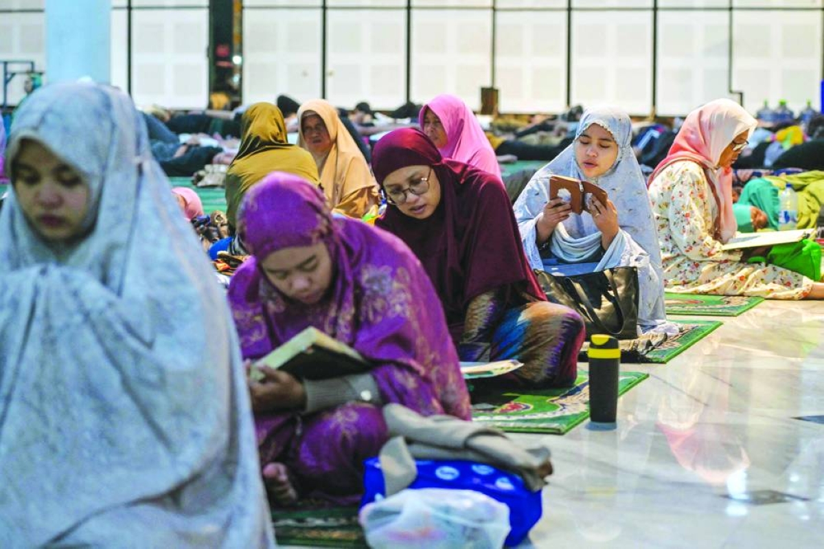 Indonesian Muslim women read the Qur’an on the 21st night of the holy month of Ramadan at the Al Akbar mosque in Surabaya early Wednesday. (AFP)
