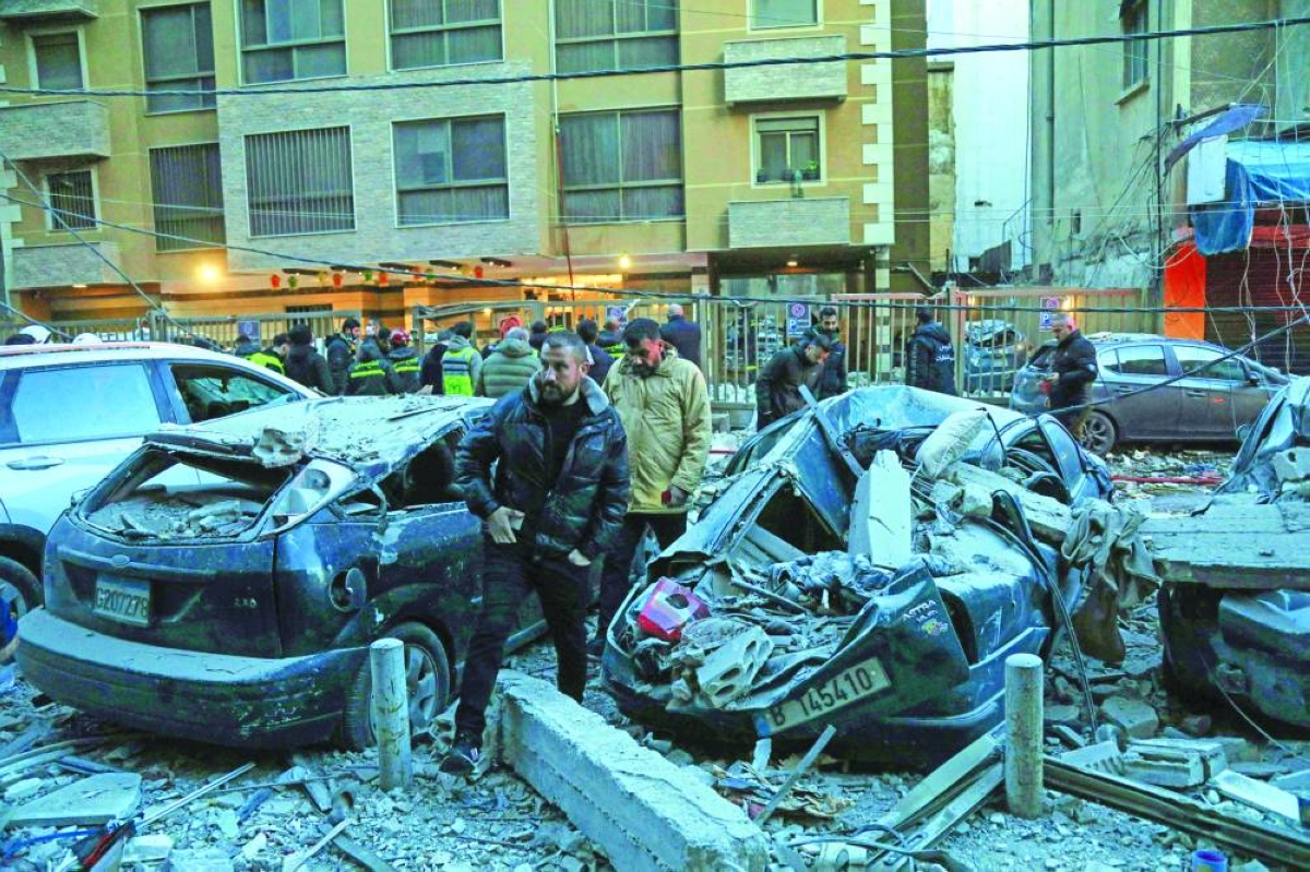Emergency personnel and residents gather at the site of an Israeli airstrike that targeted a building in the Aisha Bakkar neighbourhood of Beirut, Wednesday. (AFP)