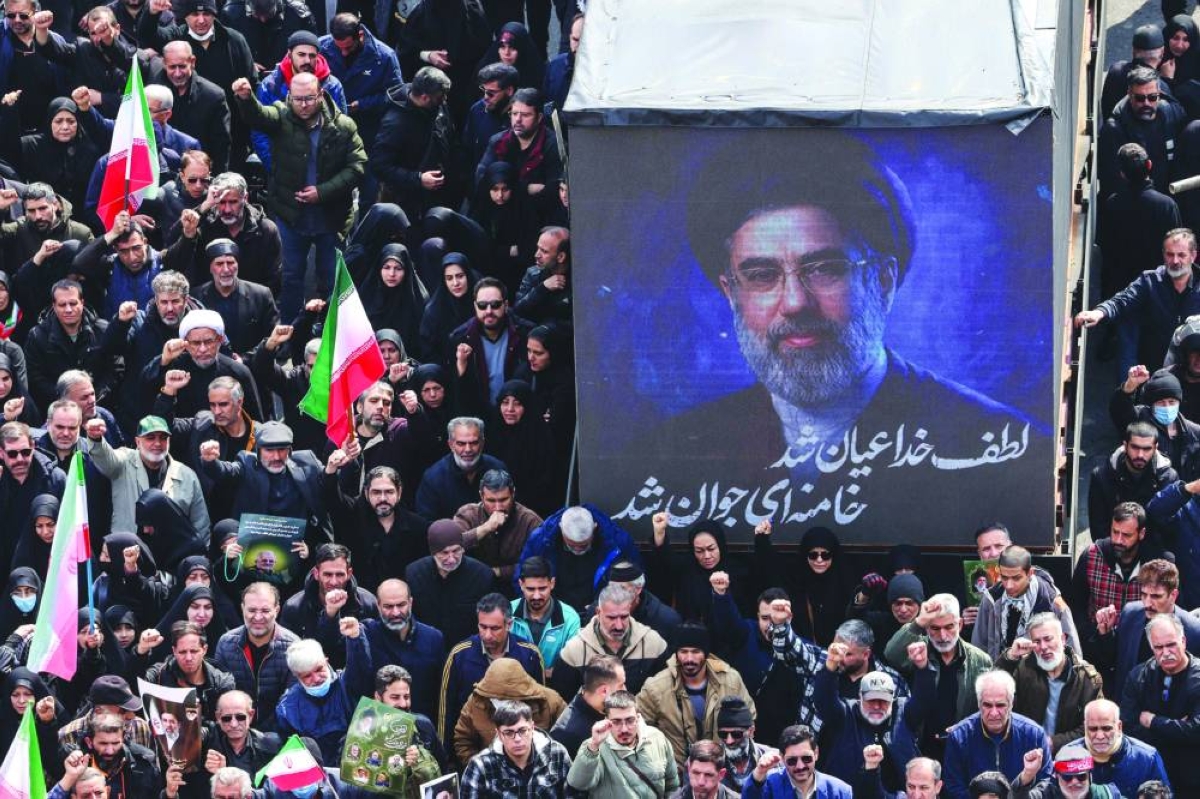 A screen displays a portrait of Iran's new supreme leader Mojtaba Khamenei during the funerals of Iran's Revolutionary Guards Corps (IRGC) commanders, army commanders and others killed in the early days of the United States and Israeli strikes on Iran, at Enghelab Square in Tehran on March 11, 2026. Washington launched strikes with Israel on Iran on February 28, sparking retaliatory strikes by Tehran against Israel and US bases across the Gulf region. (AFP) 