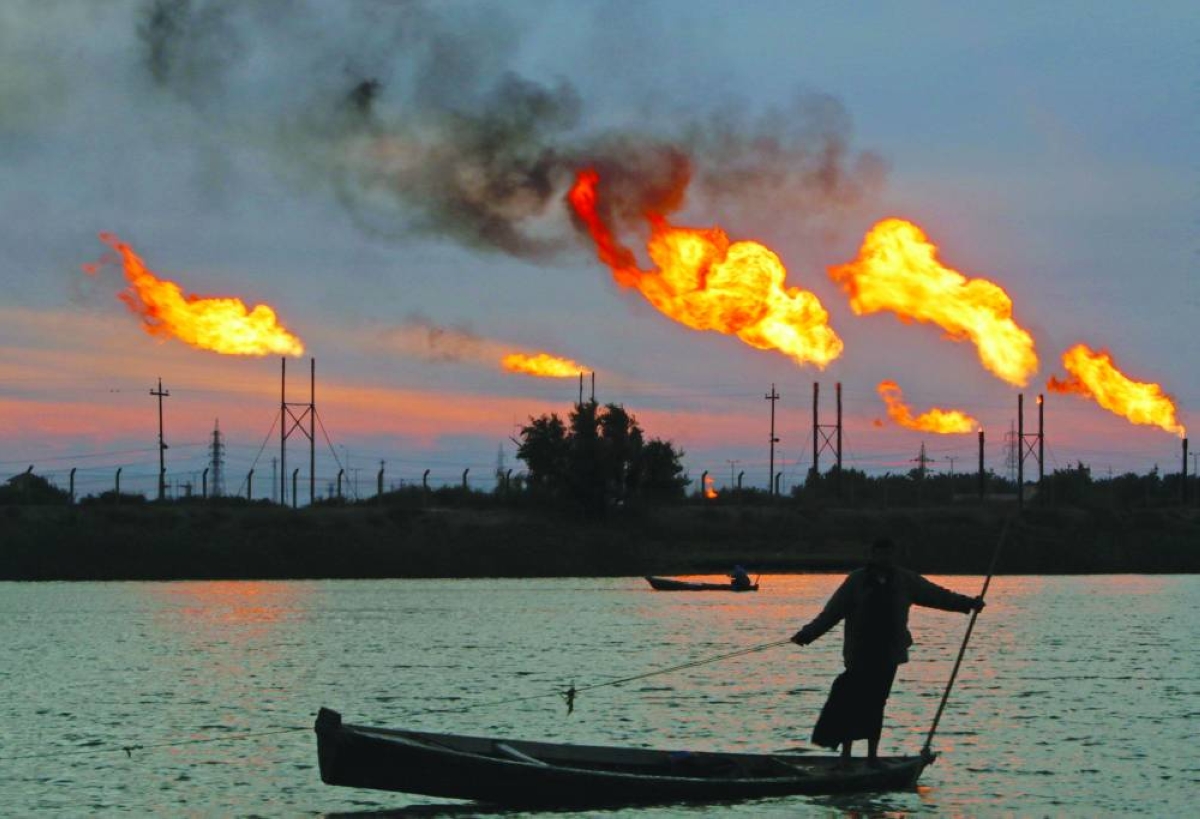 Flames emerge from flare stacks at the oil fields in Basra (file). Iraq will keep crude oil production at around 1.4mn barrels per day, ‌Oil Minister Hayan Abdel-Ghani was quoted ​as saying on ‌Thursday, less than a third of ‌the ⁠level ‌before the US-Israeli conflict ‌with Iran.