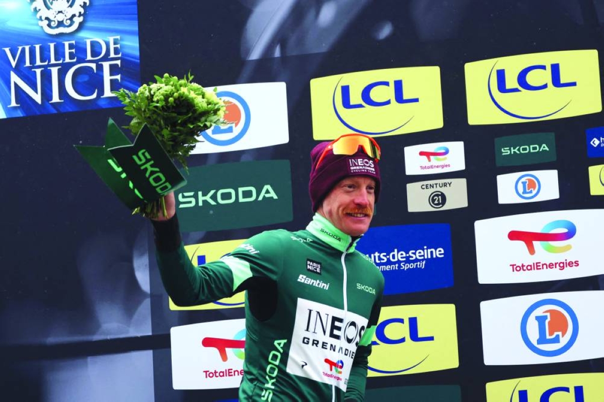 INEOS Grenadiers' French rider Dorian Godon celebrates his green jersey of best sprinter on the podium after the 7th stage of the Paris-Nice cycling race, 47 km between Le Broc and Isola-Village, Saturday. Due to deteriorating weather conditions, the route of stage 7 has been changed to a 47 km race from Le Broc to Isola. (AFP)