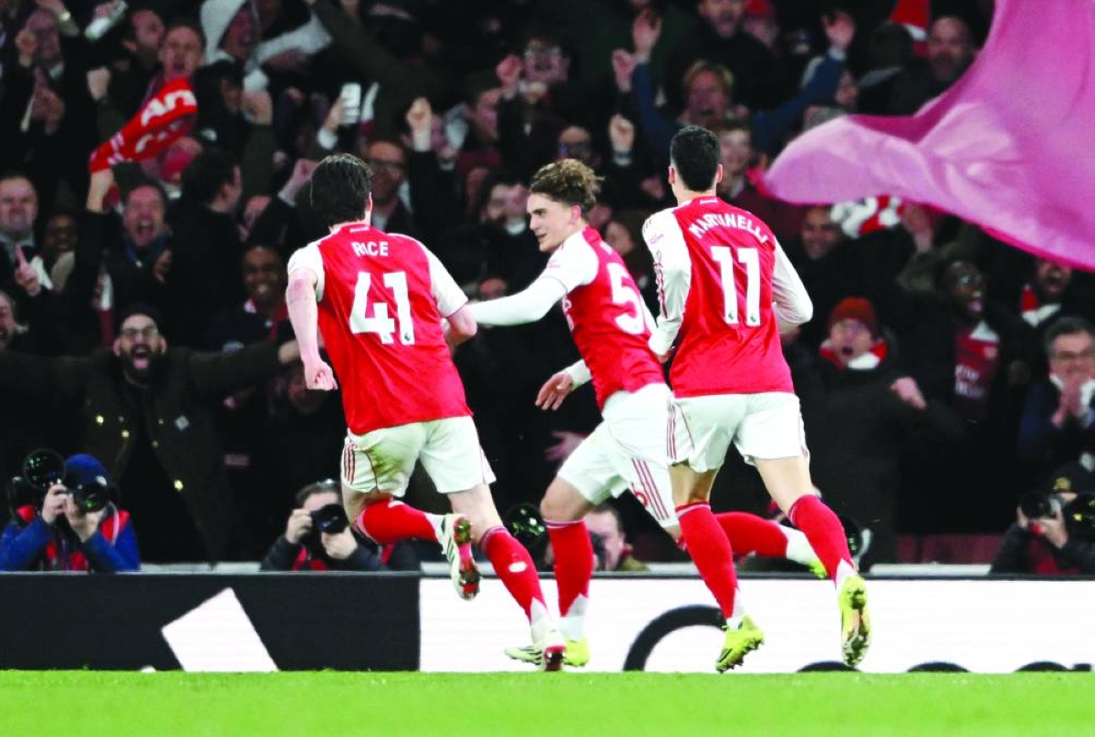 Arsenal’s Max Dowman (centre) celebrates with Declan Rice and Gabriel Martinelli after scoring against Everton in the Premier League at the Emirates Stadium in London Saturday. (Reuters)