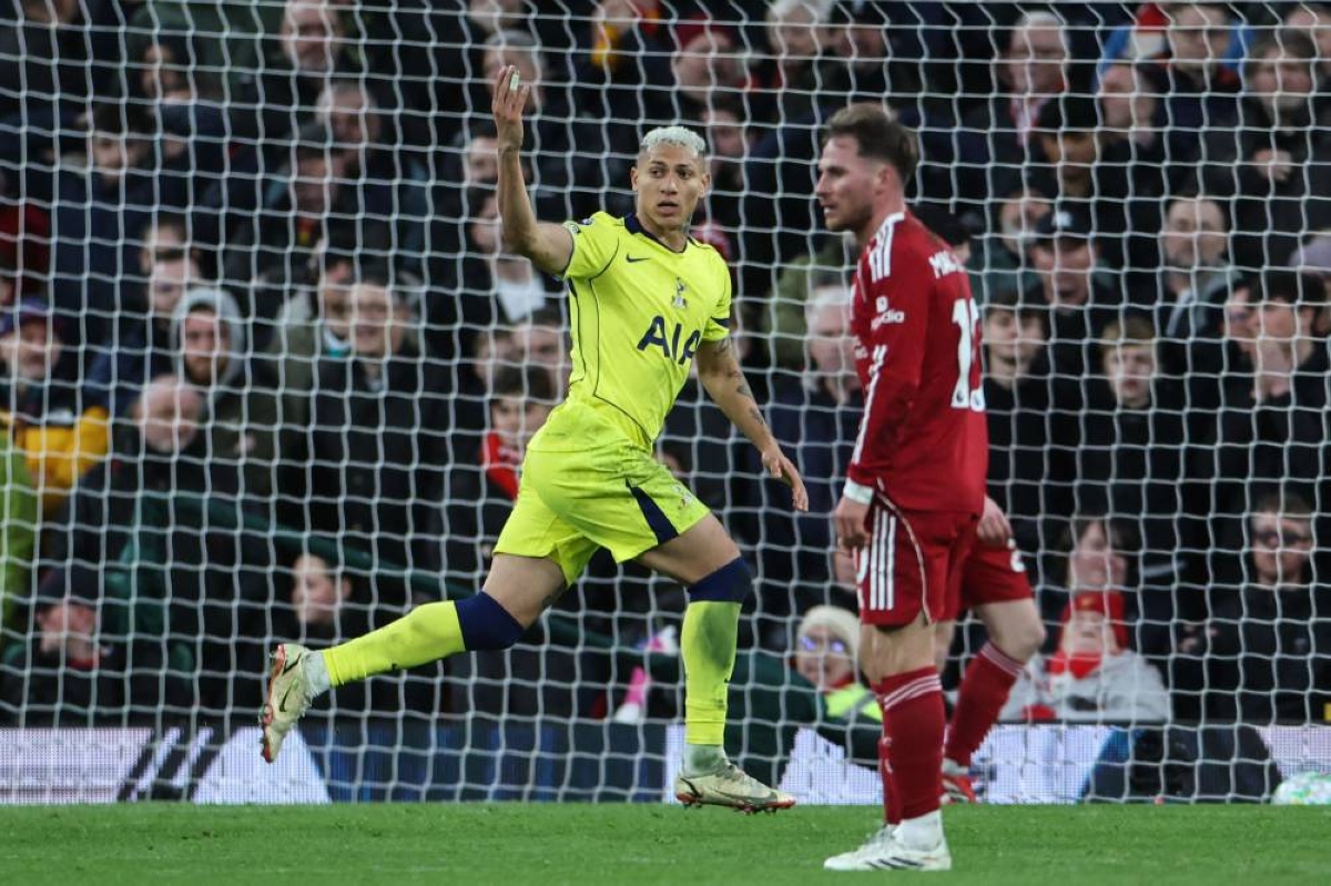 Tottenham Hotspur's Brazilian striker #09 Richarlison (L) celebrates after scoring his team's first goal to equalise, during the English Premier League football match between Liverpool and Tottenham Hotspur at Anfield in Liverpool, north west England on March 15, 2026. (AFP)