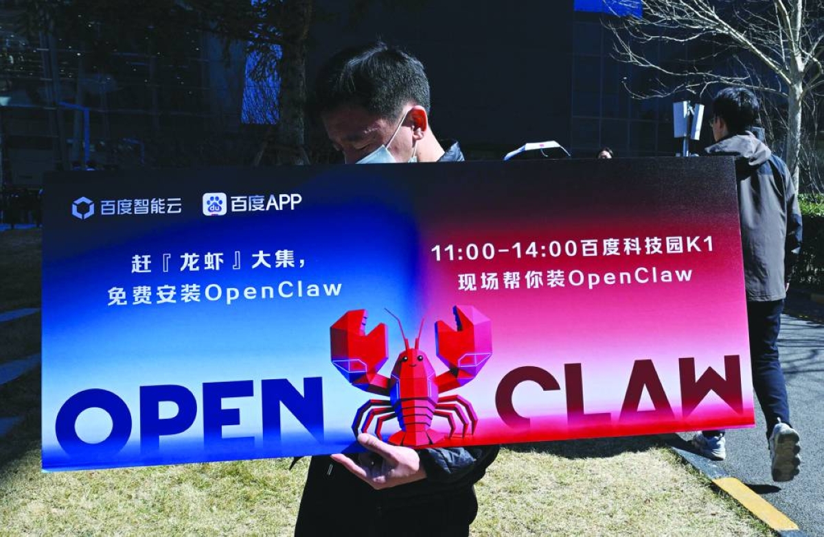 A man holds a placard featuring OpenClaw, an open-source AI assistant, during an event at the Baidu headquarters in Beijing on March 11.