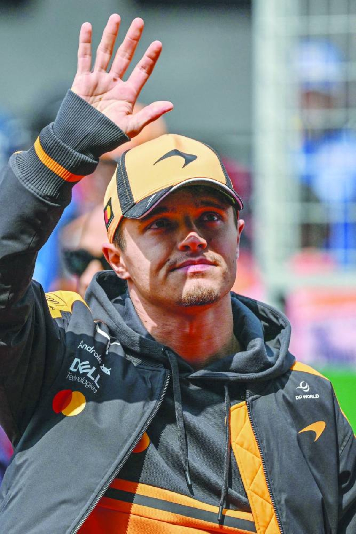 McLaren's British driver Lando Norris gestures as he arrives for the drivers' parade prior to the Formula One Chinese Grand Prix at the Shanghai International Circuit in Shanghai on March 15, 2026. (AFP)