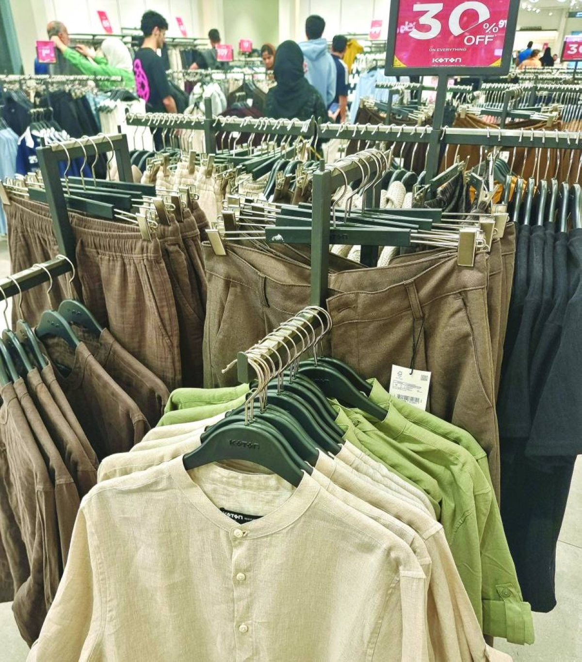 Customers sift through racks of discounted clothing as seasonal promotions draw shoppers to malls during the pre-Eid shopping rush. PICTURE: Joey Aguilar
