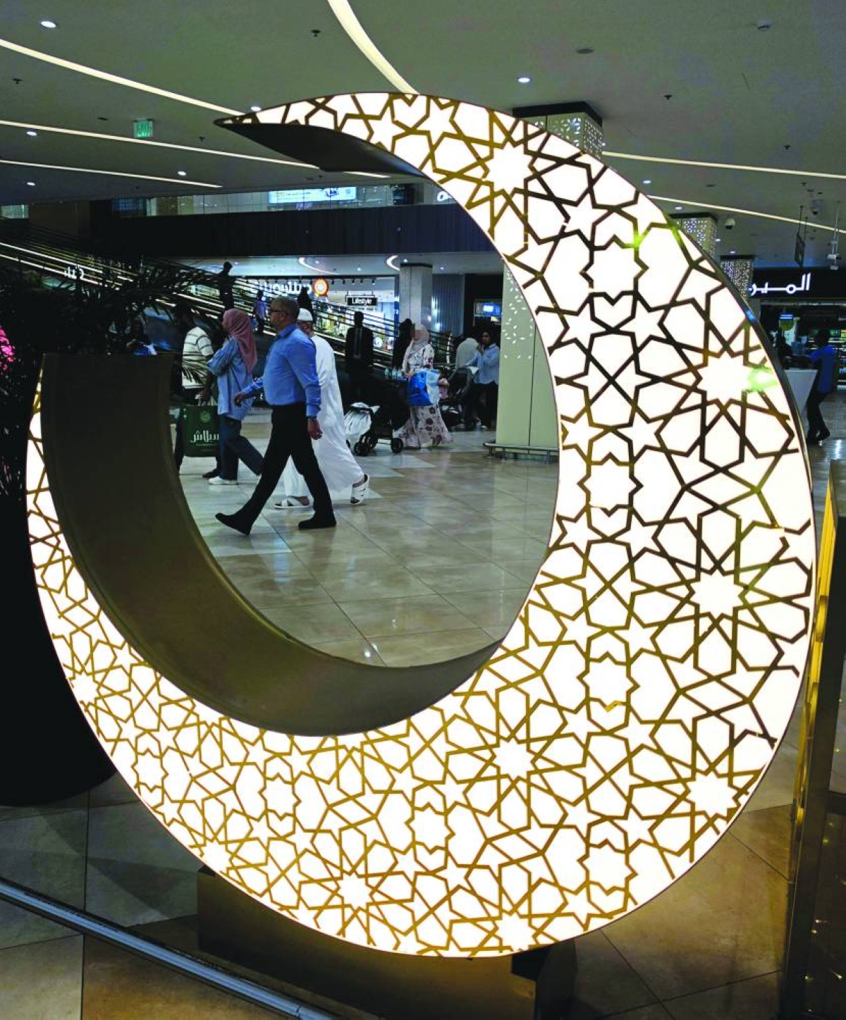 A crescent moon Ramadan-themed installation decorates a shopping mall in Doha, where increased footfall reflects the festive atmosphere and last-minute preparations for Eid. PICTURE: Joey Aguilar
