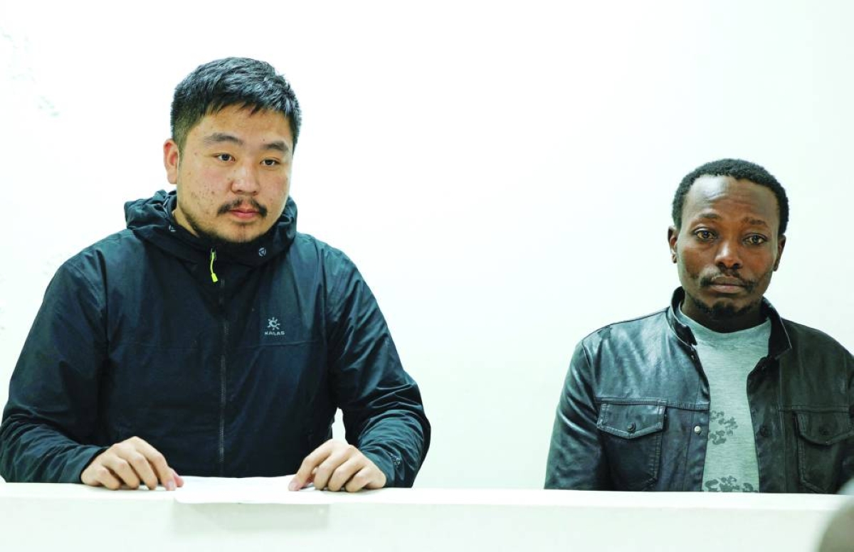 Chinese national Zhang Kequn and Kenyan national Charles Mwangi stand after they were charged with dealing with wildlife species without a permit and illegal possession of garden ants, at the Jomo Kenyatta International Airport (JKIA) Law Courts, in Nairobi, Tuesday. (Reuters)