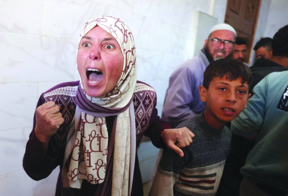 Displaced Palestinians react during the funeral of people that were reportedly killed by an Israeli strike, at the Nasser Hospital in Khan Younis, in the southern Gaza Strip, Tuesday. (AFP)