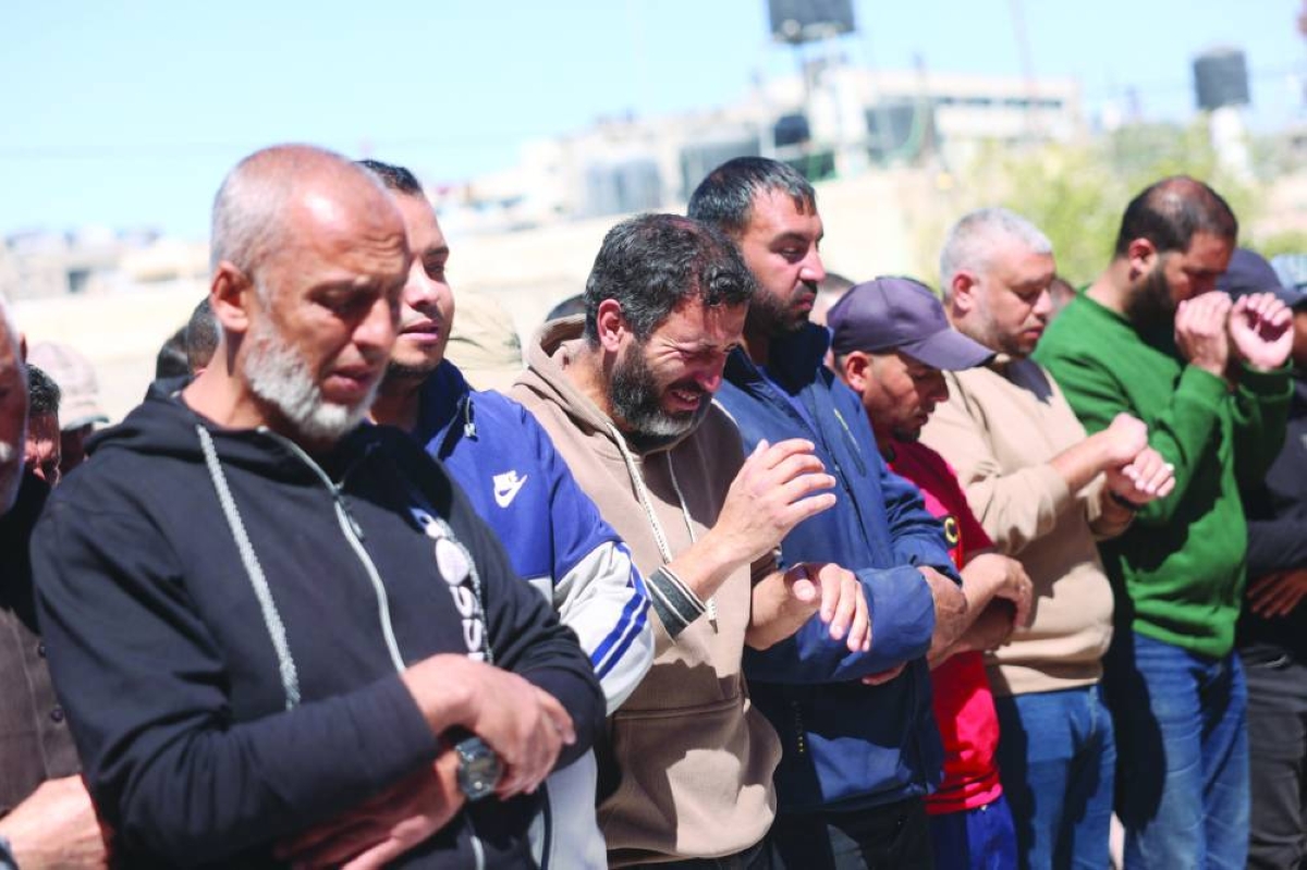Displaced Palestinians mourn during the funeral of people that were reportedly killed by an Israeli strike, at the Nasser Hospital in Khan Younis, in the southern Gaza Strip, Tuesday. (AFP)