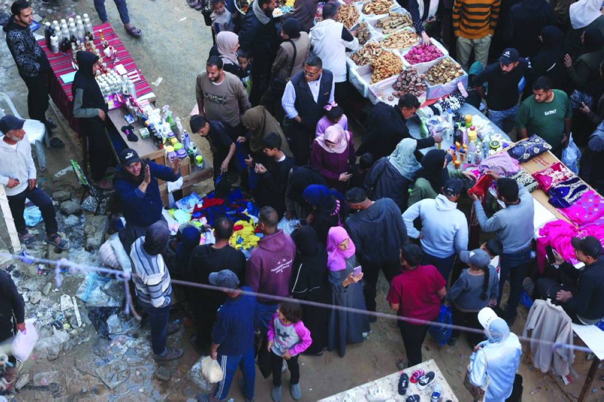 Displaced Palestinians shop at a street market as they prepare for Eid al-Fitr, the holiday marking the end of the holy fasting month of Ramadan, in Khan Younis in the southern Gaza Strip, Tuesday. (AFP)