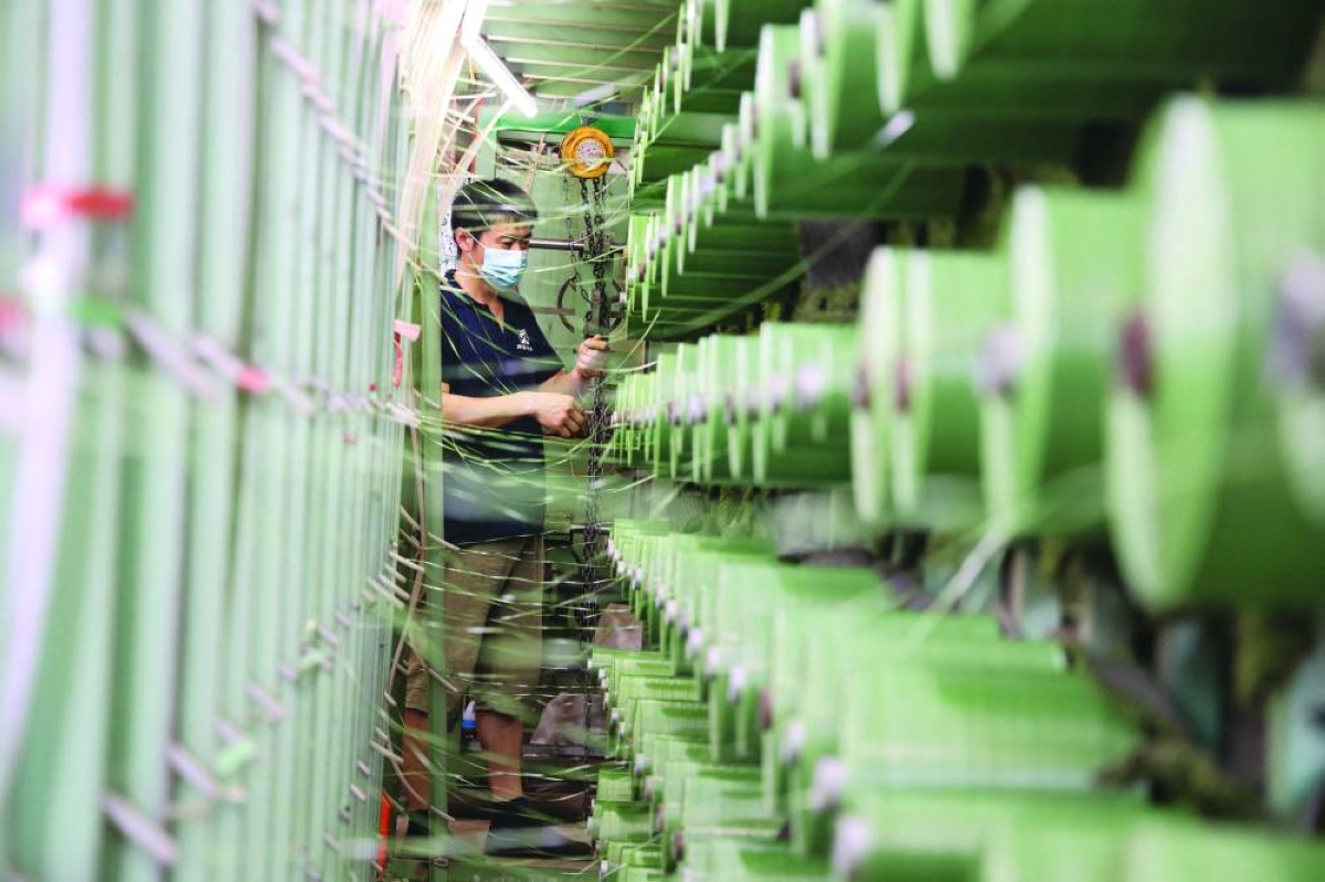 A worker produces fiber netting at a factory in Binzhou in China's eastern Shandong province. China’s economy rebounded in early 2026 with a surprising uptick in domestic consumption and investment, an acceleration that may prove hard to sustain if the war in Iran stalls exports. 