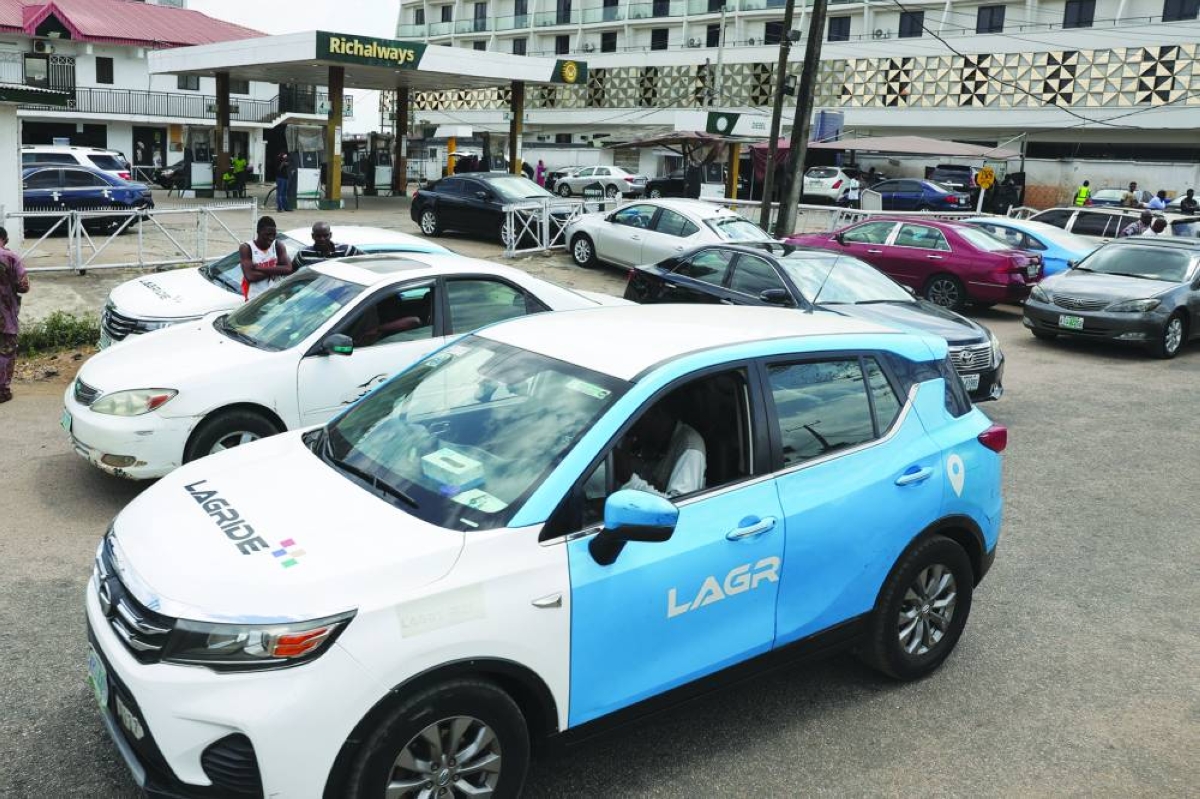Nigerian ride-hailing drivers working with Uber, Bolt and inDrive park near a filling station as they protest in Lagos over low fares, urging the Lagos State Assembly to mandate higher rates amid surging petrol prices linked to the Iran conflict, in Lagos, Nigeria, Wednesday. (Reuters)