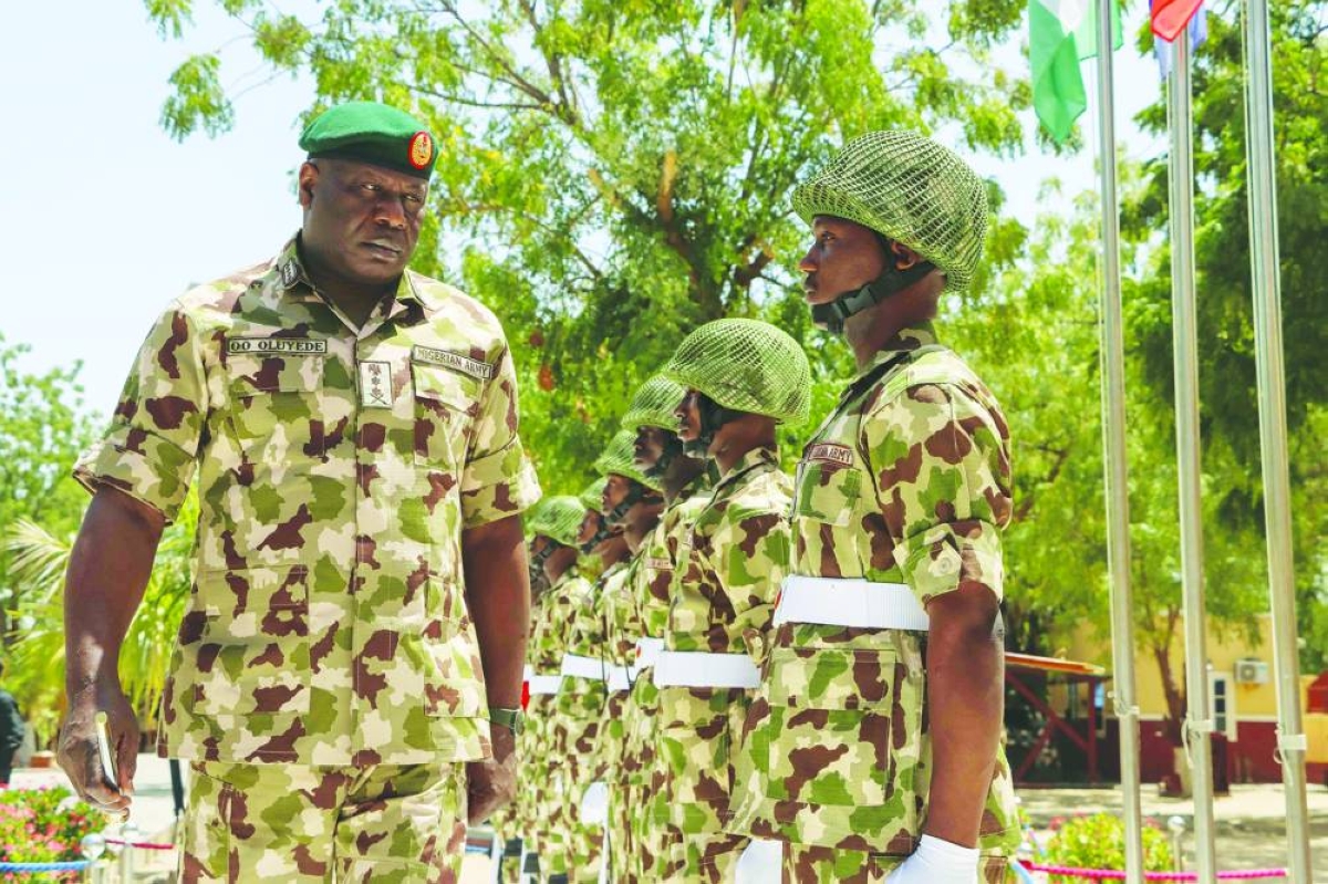 Nigeria's Chief of Defence Staff General Olufemi Oluyede (left) inspects the guard of honour at the Headquarters Theatre Command Joint Task Force in Maiduguri, Wednesday during his visit after one of the deadliest attacks in the Borno state capital in years. (AFP)
