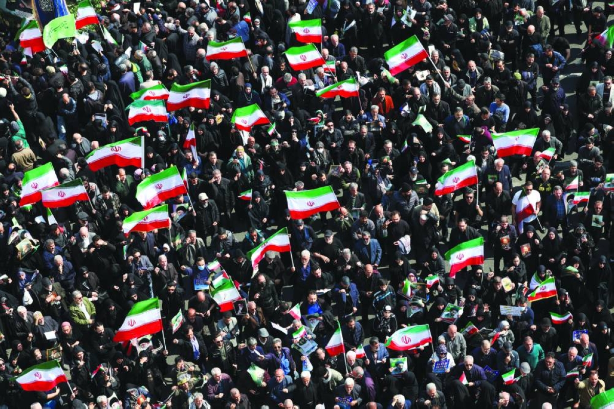 People gather for the funeral of Iranian security chief Ali Larijani and victims of the IRIS Dena warship at Enghelab Square, amid the US-Israeli conflict with Iran, in Tehran, Wednesday. (Reuters)