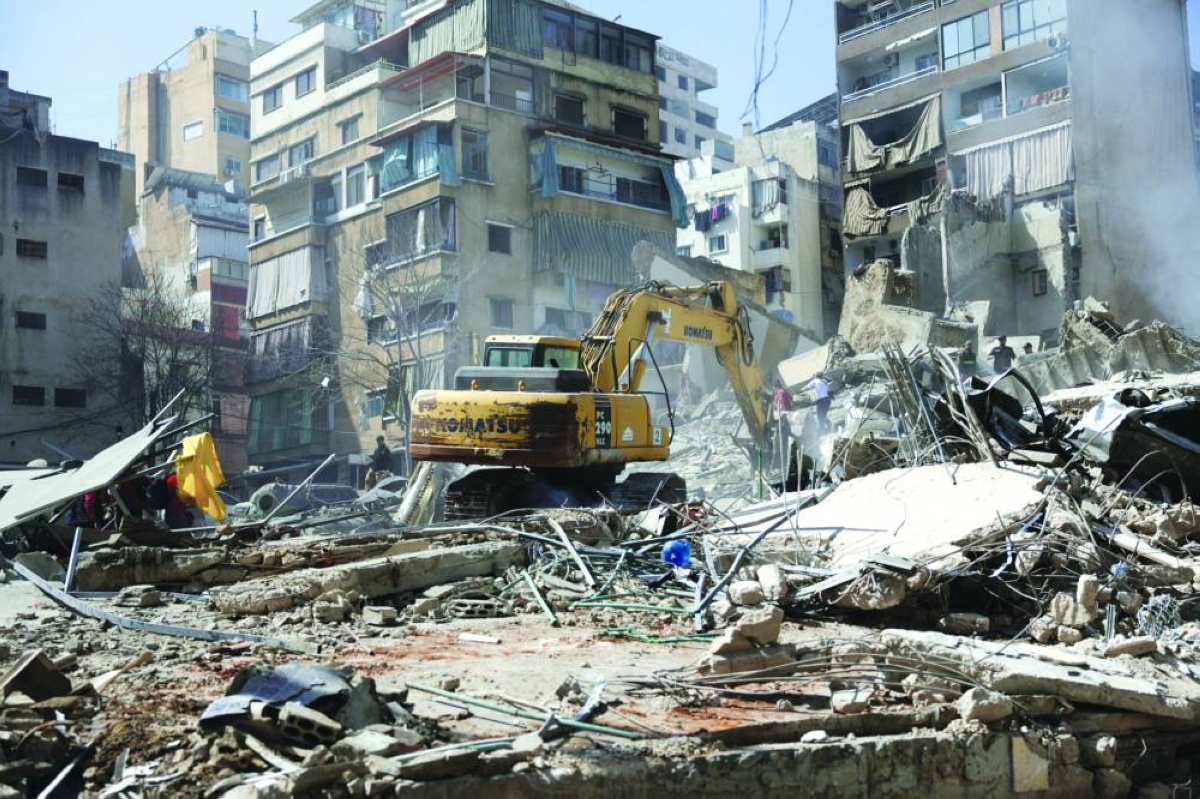 Excavator cleans debris at the site of an Israeli strike, following an escalation between Hezbollah and Israel amid the US-Israeli conflict with Iran, Zuqaq al-Blat district in central Beirut, Wednesday. (Reuters)
