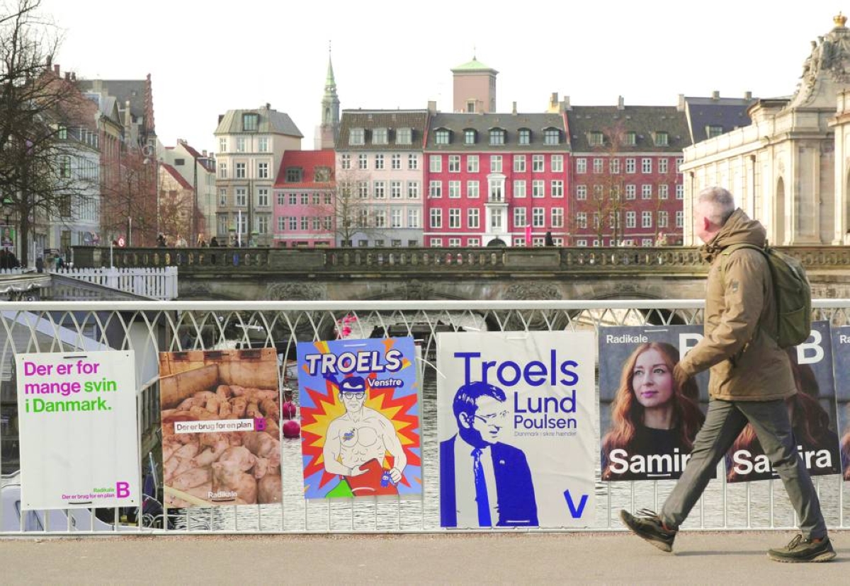 
A pedestrian walks past posters for candidates in the upcoming Danish elections, in Copenhagen, Denmark. (Reuters) 