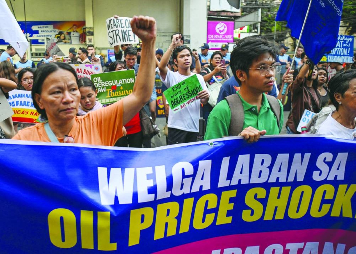 Jeepney drivers and activists display placards during a protest in support of a jeepney drivers' strike in Manila Thursday. (AFP)