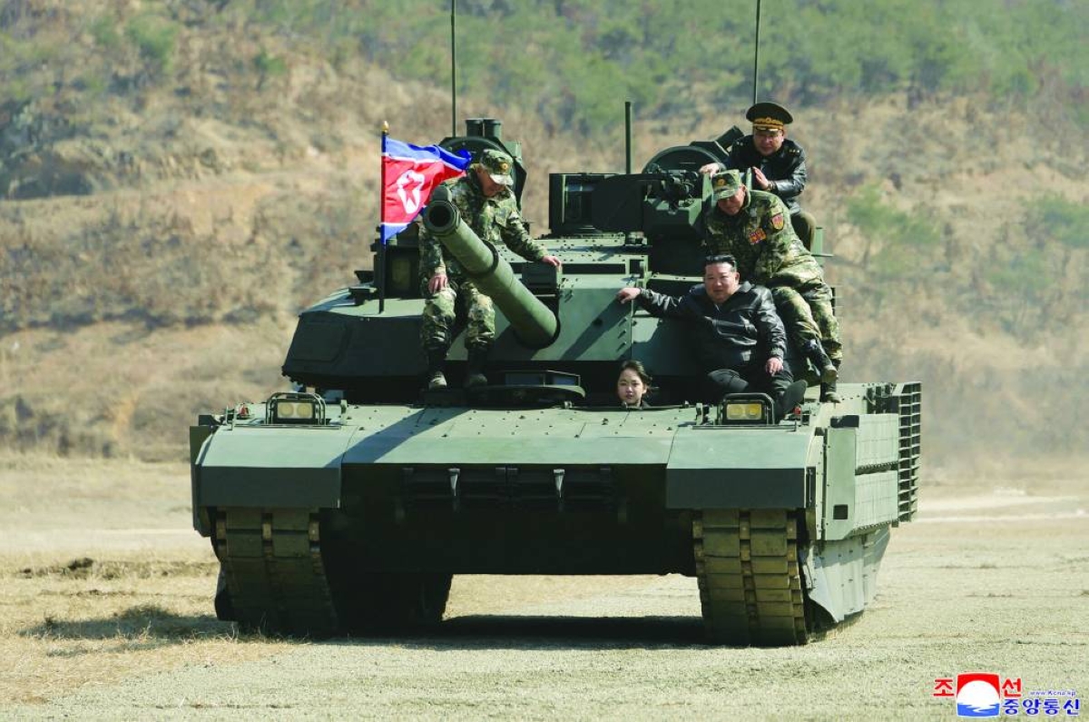 North Korean leader Kim Jong-un and his daughter Kim Ju-ae aboard a tank at the Pyongyang Training Base No 60 under the Capital City Defence Corps of the North Korean's Army on Thursday. (AFP) 