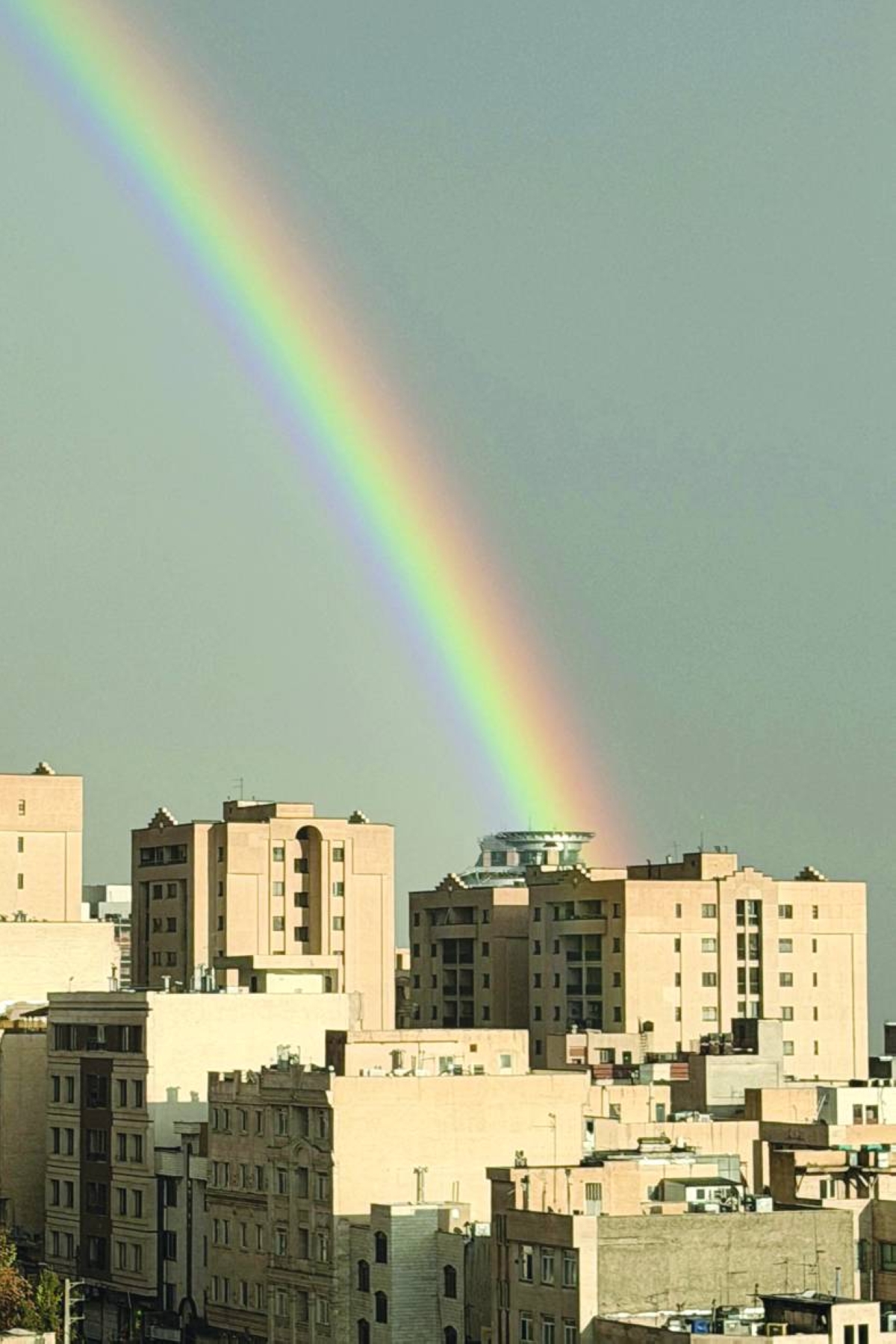 A rainbow arcs above the building as Iranians celebrate the spring holiday of Nowruz in Tehran. AFP