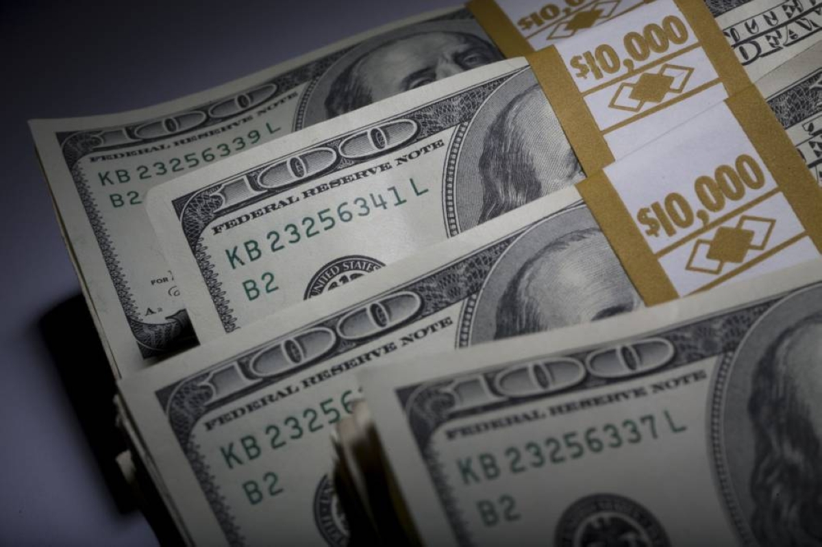 Stacks of US $100 bills are arranged for a photograph in New York. Traders turned positive on the US dollar for the first time this year as war in the Middle East jolts energy costs higher and supports the currency’s status as a haven. 