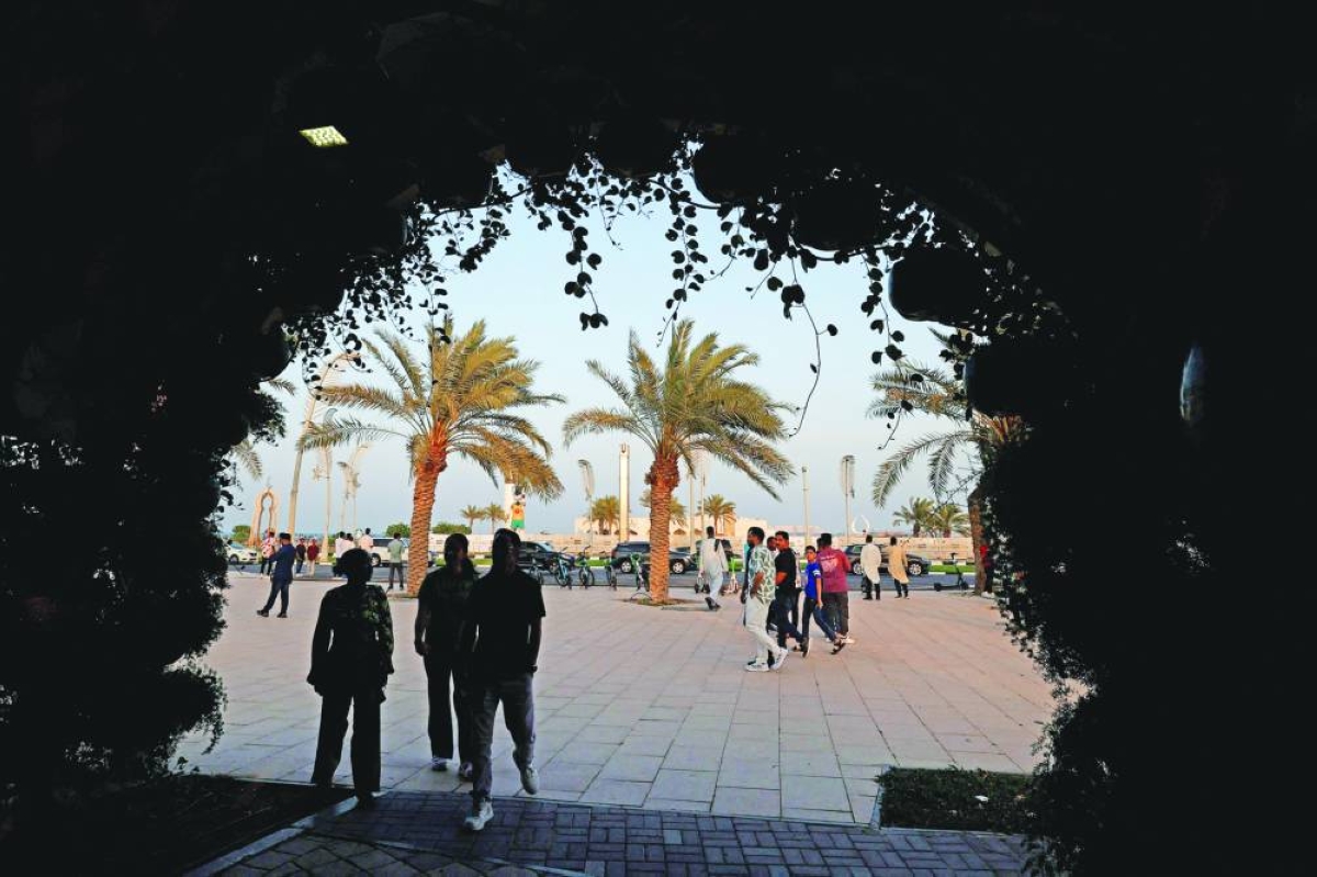 Residents walk along the Corniche, on the second day of Eid al-Fitr. – AFP