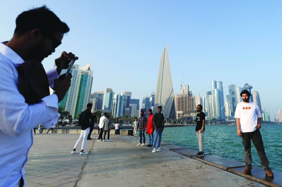 A man has his photograph taken as he poses along the Corniche Saturday. – AFP