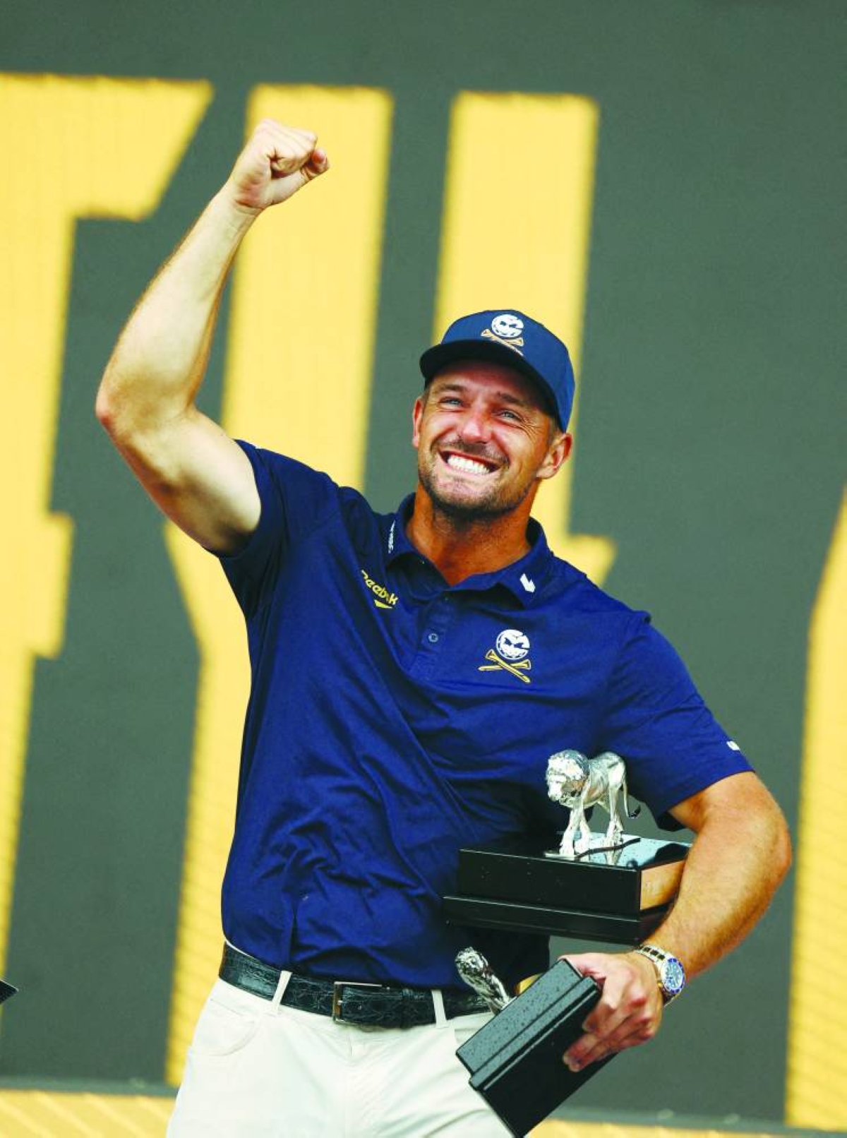 Bryson DeChambeau celebrates with his trophies after winning the LIV Golf South Africa individual and team events.(Reuters)