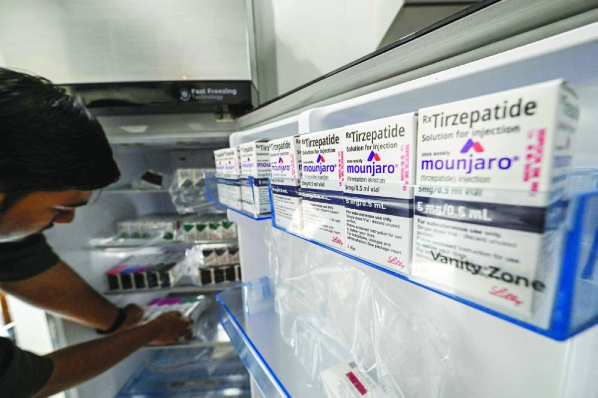 
A medicine distributor stores Mounjaro (tirzepatide) self-injecting GLP-1 prefilled pens and vials in a fridge at his office in Thane. (AFP) 