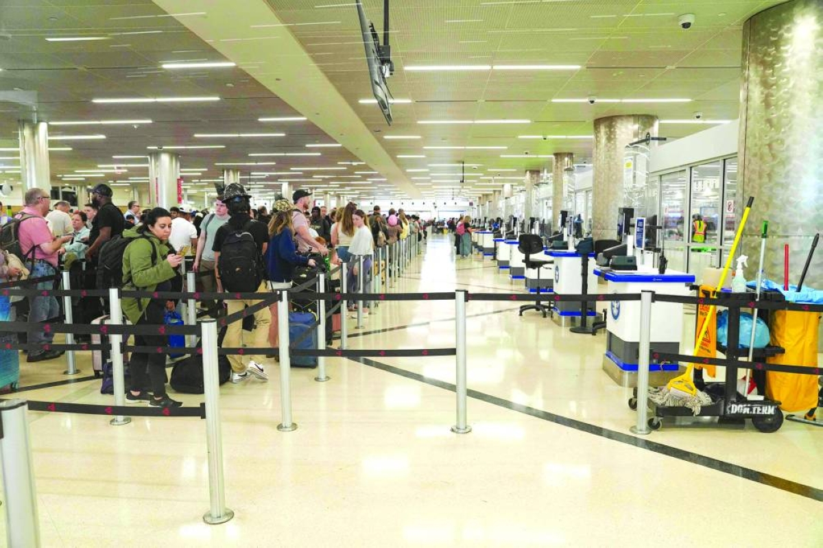 TSA desks sit empty as travellers stand in long lines at Atlanta Hartsfield-Jackson International Airport Sunday in Atlanta, Georgia. (AFP)