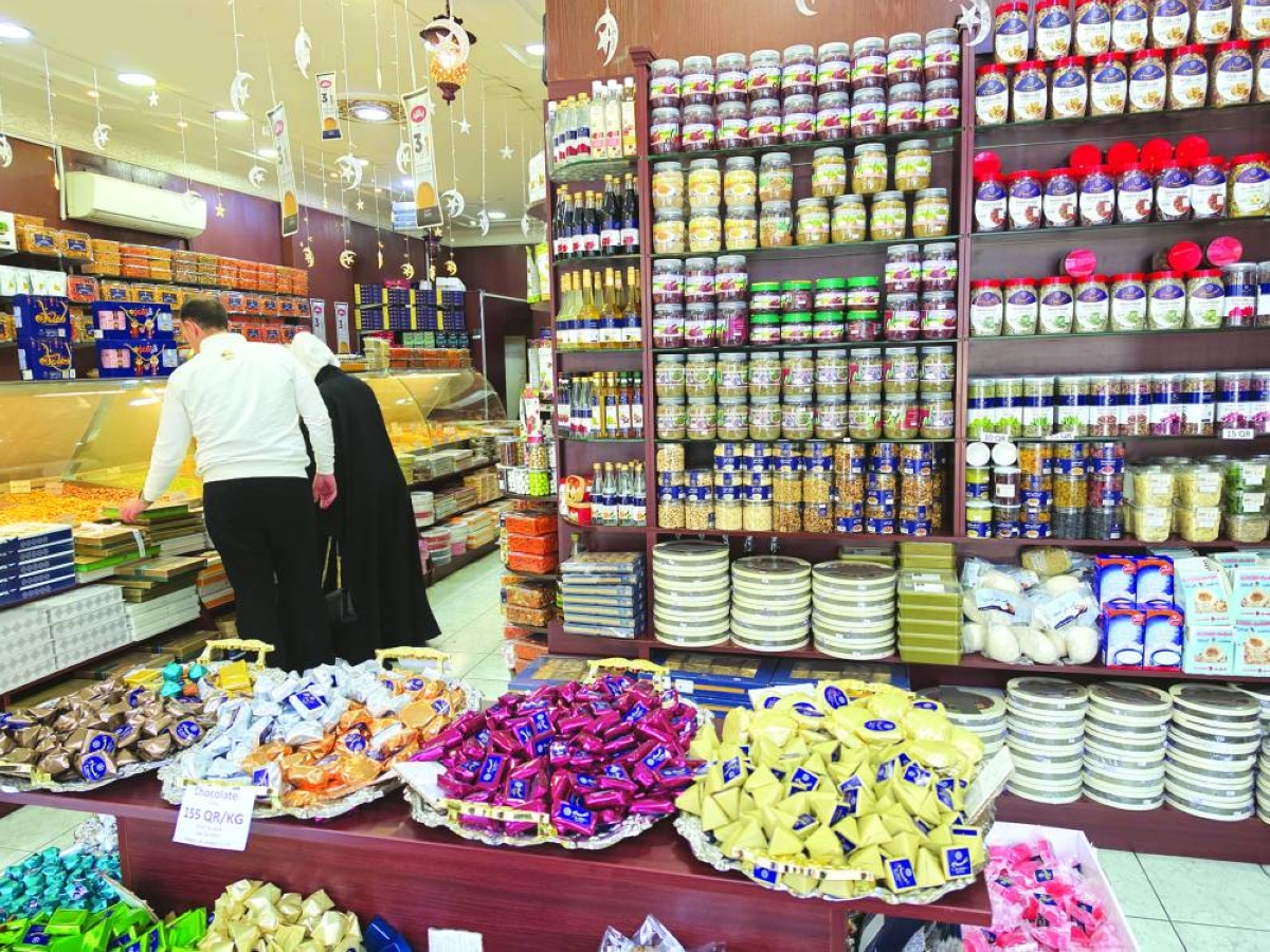 Shoppers browse neatly arranged shelves of packaged sweets and gift boxes at a store during the Eid holiday. 
PICTURE: Joey Aguilar