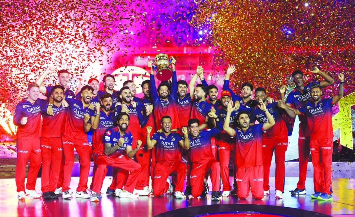 
Royal Challengers Bengaluru players celebrate with the trophy after winning the Indian Premier League title against Punjab Kings in Ahmedabad, India, on June 4, 2025. (Reuters) 