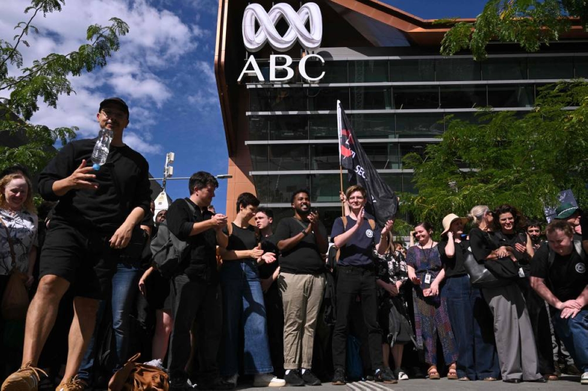 Journalists and staff walk out of the Australian Broadcasting Corporation headquarters on strike demanding better pay and protections to stop artificial intelligence taking their jobs, in Melbourne, Wednesday. (AFP)