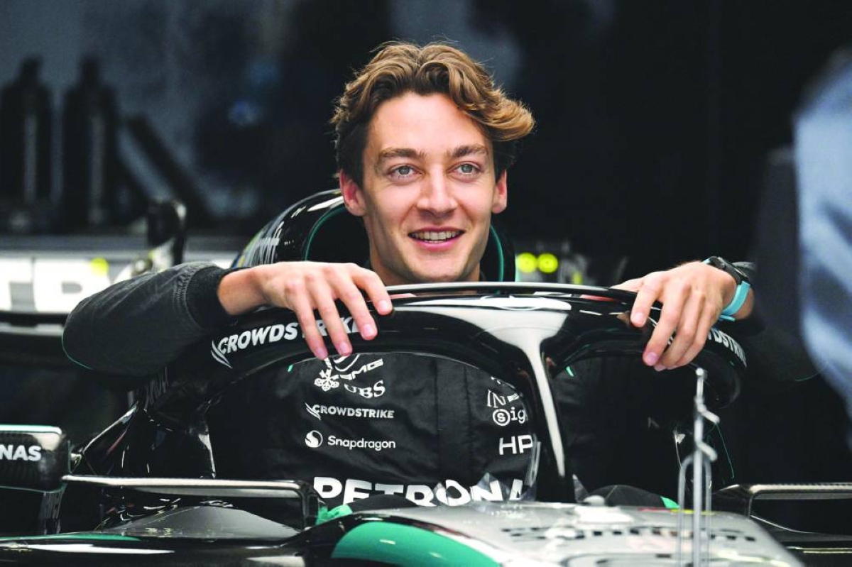 Mercedes' British driver George Russell poses for photos in his car during preparations ahead of the Formula One Chinese Grand Prix at the Shanghai International Circuit in Shanghai on March 12, 2026. (AFP)