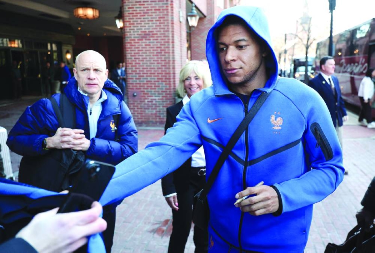 France's forward Kylian Mbappe signs autographs upon arriving at the hotel in Boston on March 24, 2026. France will play two friendly matches against Brazil on March 26 in Boston and against Colombia on March 29 in Landover. (AFP)