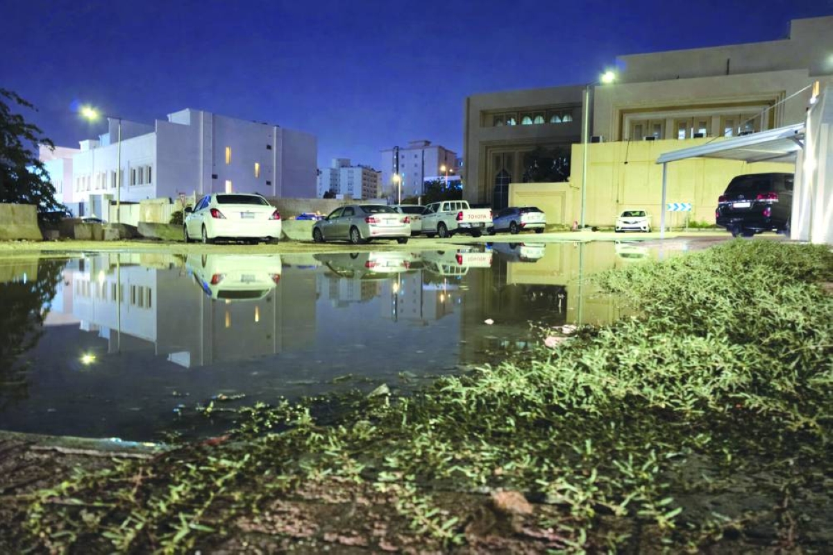 Floodwaters pooled along a residential street last night, turning parked cars into mirror-like reflections. 
PICTURE: Joey Aguilar