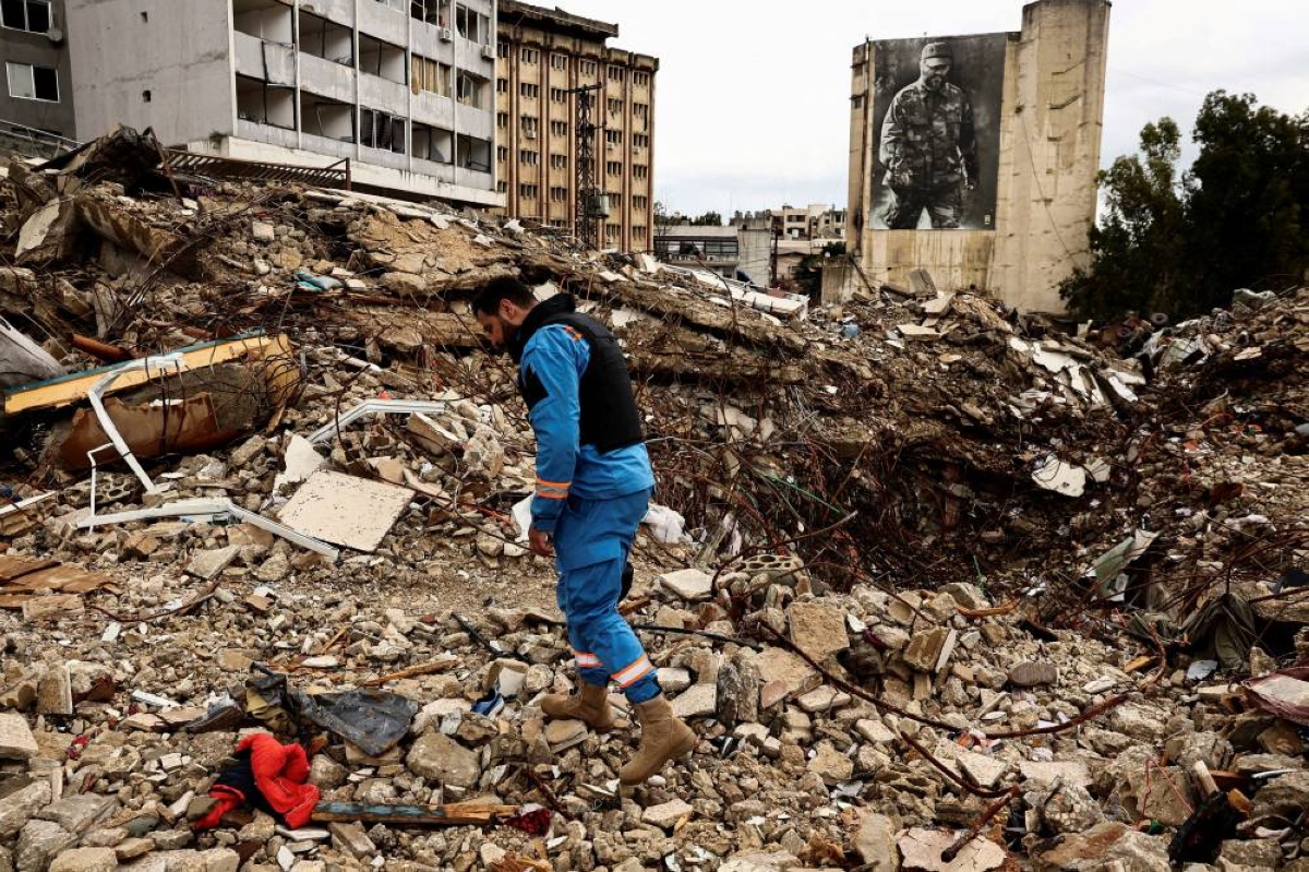 A paramedic walks among the rubble at a site damaged in an Israeli strike, amid escalating hostilities between Israel and Hezbollah, as the US-Israeli conflict with Iran continues, in Nabatieh, Lebanon, yesterday. (Reuters)