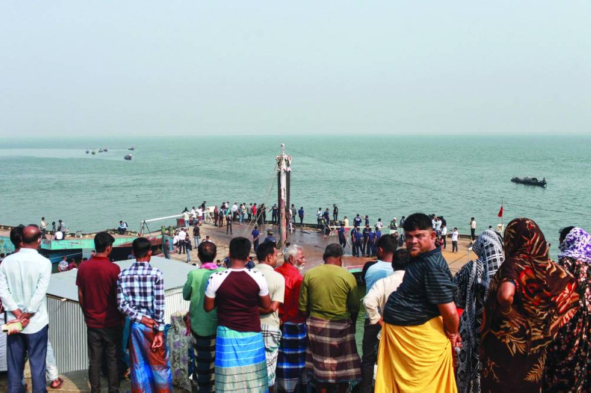 Onlookers gather near the scene of an accident involving a bus that plunged into the Padma River in Goalanda in Bangladesh’s Rajbari district Thursday. (AFP)