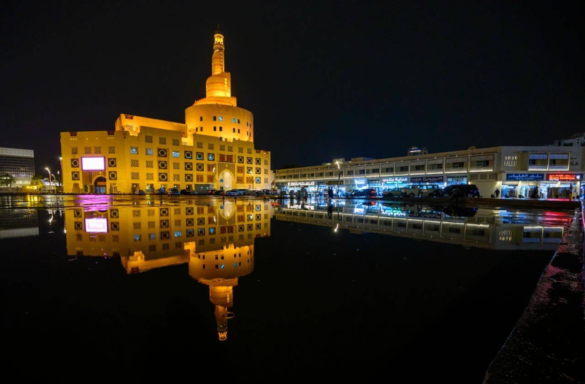 Rainwater reflects the illuminated Fanar Islamic Cultural Centre as heavy downpours and thunderstorms sweep across Qatar, disrupting traffic and daily routines while authorities urge caution amid continuing unstable weather conditions. PICTURE: Noushad Thekkayil
