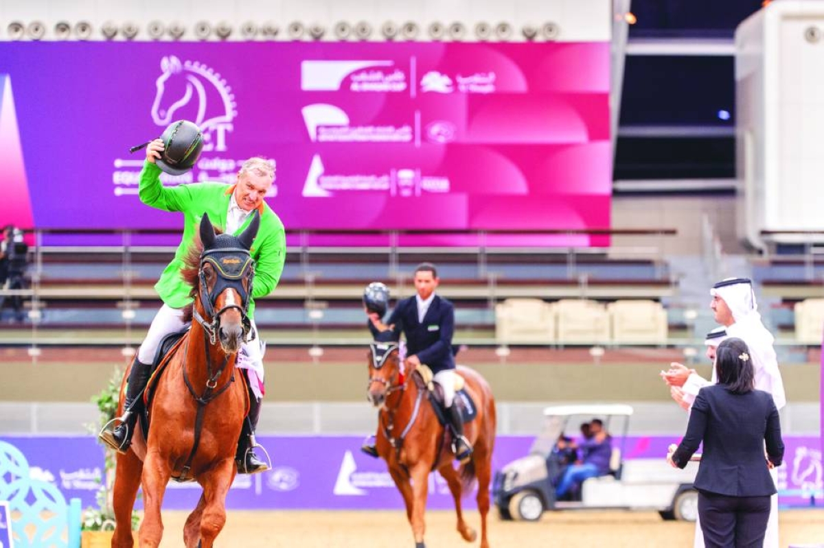 
Austria’s Gerfried Puck, onboard Equitron Naxcel V, celebrates after winning the CSI5* Jump-Off 155cm calss at the Longines Arena at Al Shaqab. 