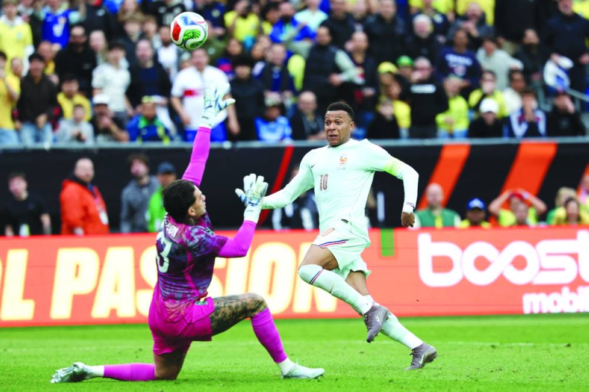 
France’s Kylian Mbappe shoots past Brazil’s goalkeeper Ederson during a friendly match at Gillette Stadium in Foxborough, Massachusetts, on Thursday. (AFP) 